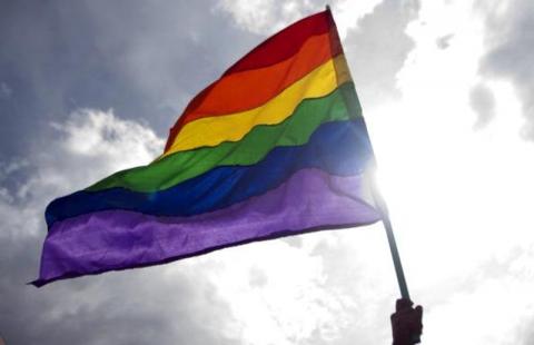 "Some young people are being forced by desperate parents to undergo a widely discredited therapy." A rainbow flag waves in front of the sun. (Getty)